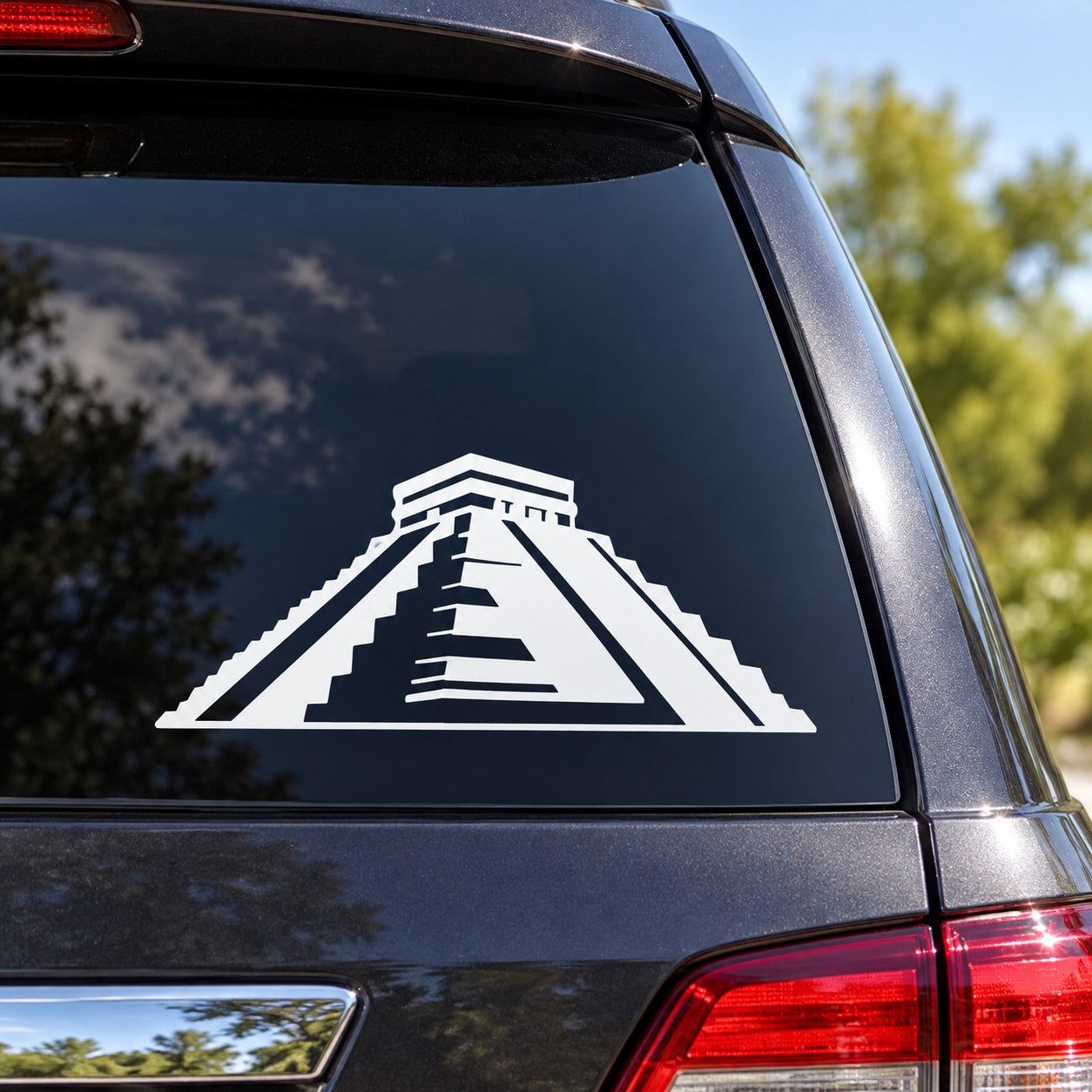 Aztec pyramid decal with white geometric pyramid icon on dark car window