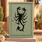 Black abstract scorpion decal with spiky crawler design on a green mailbox door