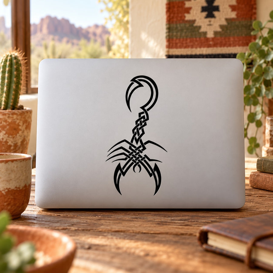 Black cross-hatch scorpion decal on laptop lid