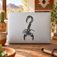 Black cross-hatch scorpion decal on laptop lid