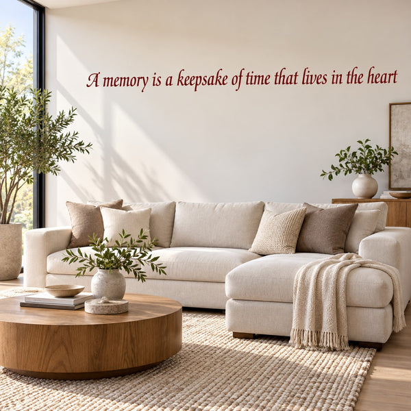 Wall decal with cursive quote: 'A memory is a keepsake of time that lives in the heart'