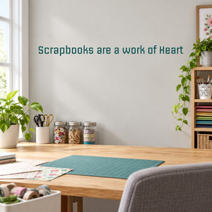 Heart-themed wall decal with teal text: 'Scrapbooks are a work of Heart'