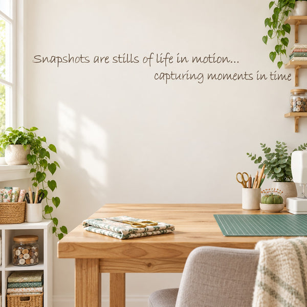 Wall decal with cursive quote: “Snapshots are stills of life in motion”