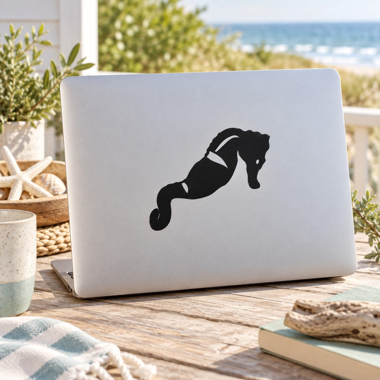 Black leaning seahorse decal sticker on white laptop lid