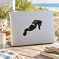 Black leaning seahorse decal sticker on white laptop lid