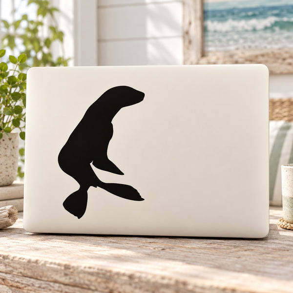 Sea lion turning decal with black sea lion silhouette on a white rectangular surface