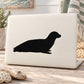 Seated seal decal with black seal silhouette on white backing