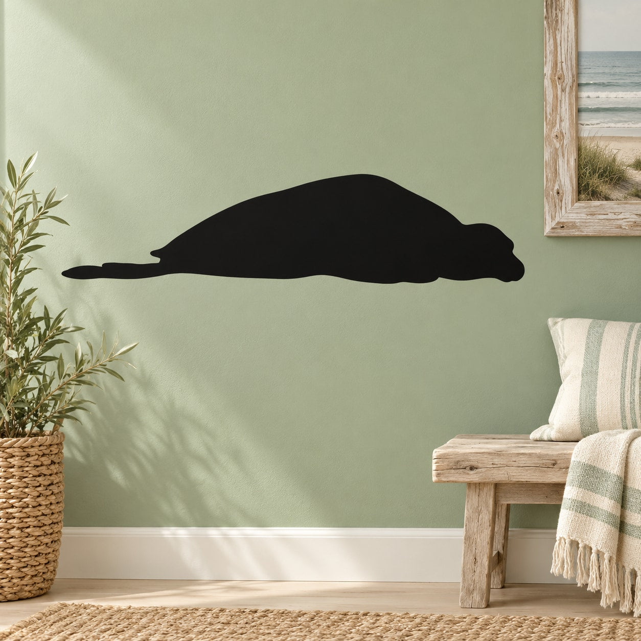 Snoozing seal wall decal, black silhouette on a flat surface