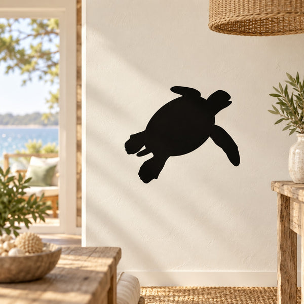 Black sea turtle surfing decal silhouette on a light wall