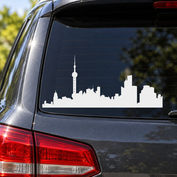 White city skyline decal with tall tower on car rear window