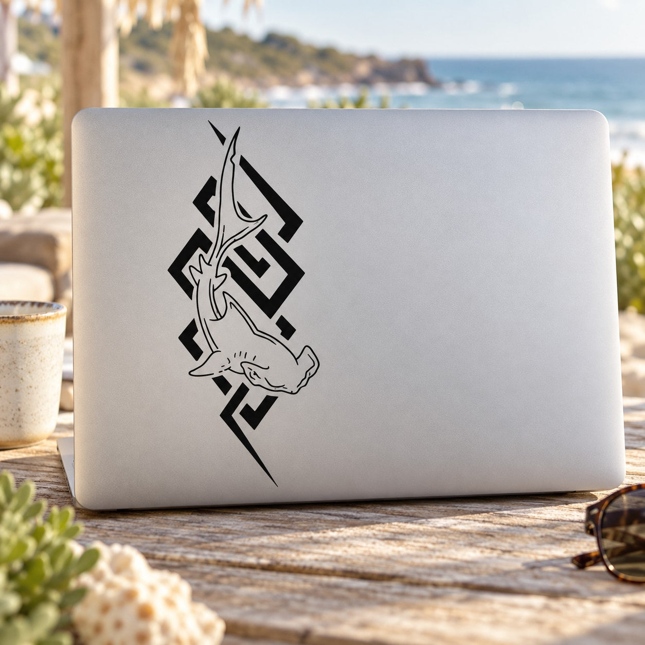 Laptop with black tribal hammerhead shark decal on the lid