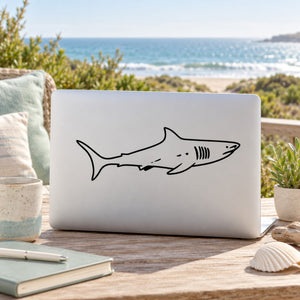 Great white shark decal in black line-art on a white laptop lid