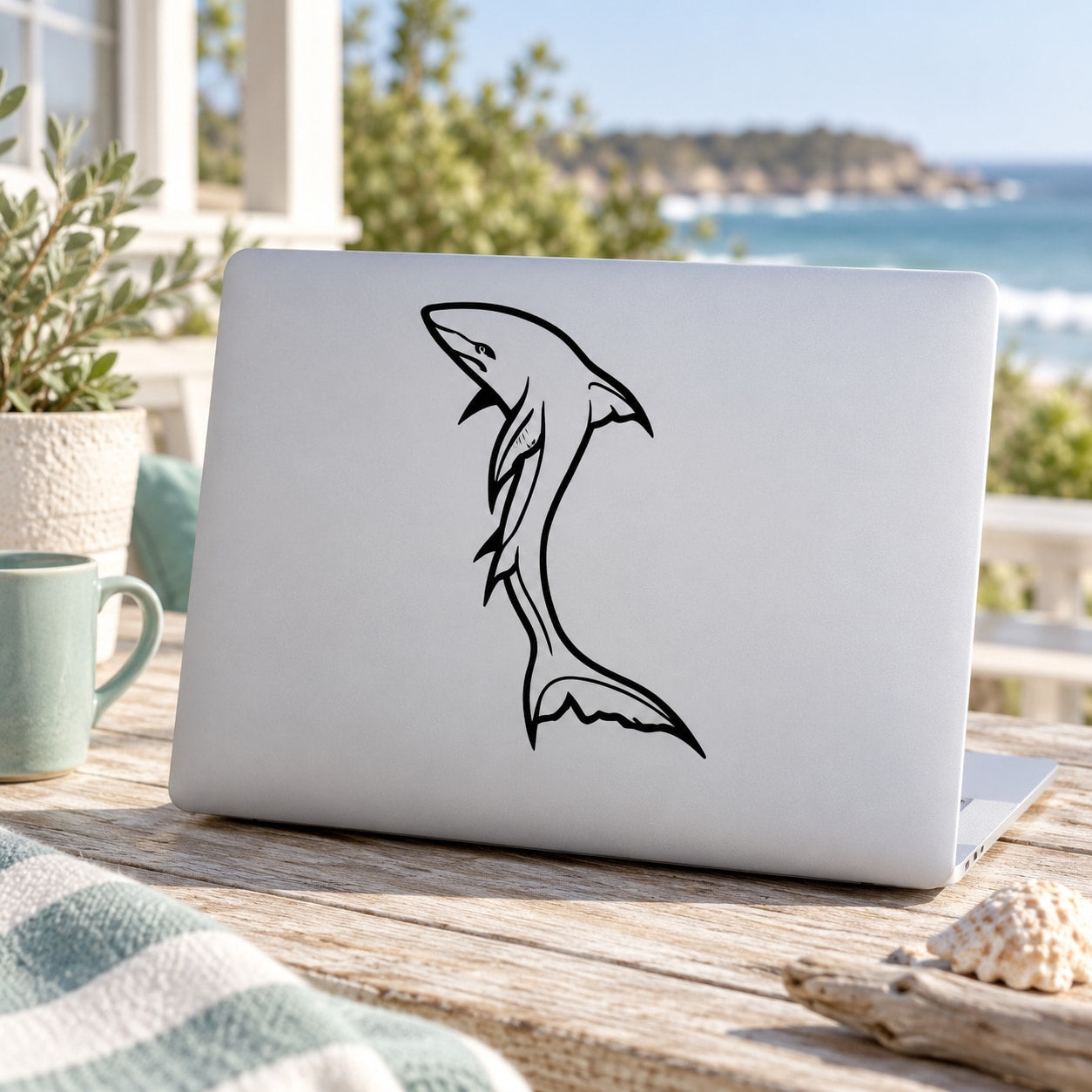 White tip shark line-art decal on light laptop lid