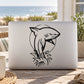 Black shark decal with seaweed on light laptop lid