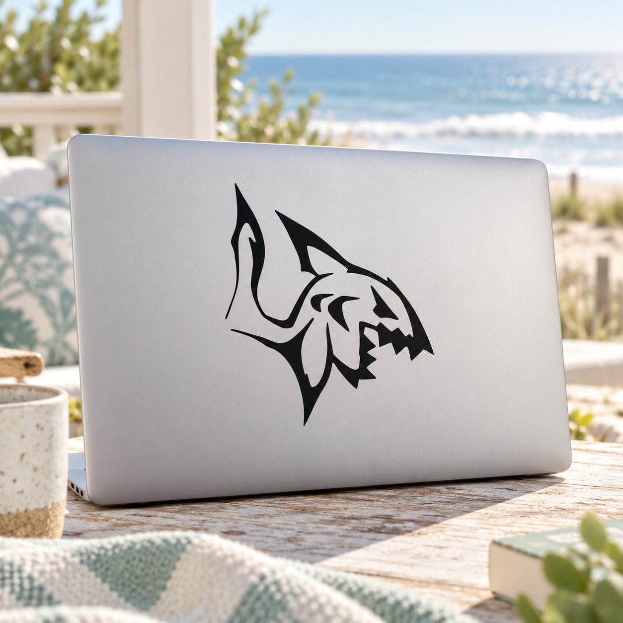Vicious shark decal in black on a light-colored laptop