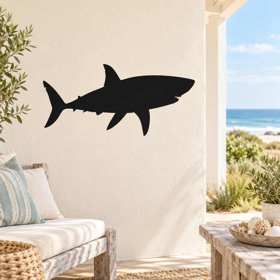 Shark swimming decal in dark silhouette, long fins and tail shape on a wall