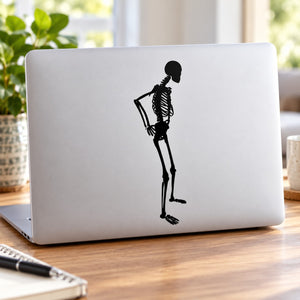 Skeleton contemplating decal silhouette on a light laptop lid