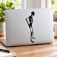 Skeleton contemplating decal silhouette on a light laptop lid