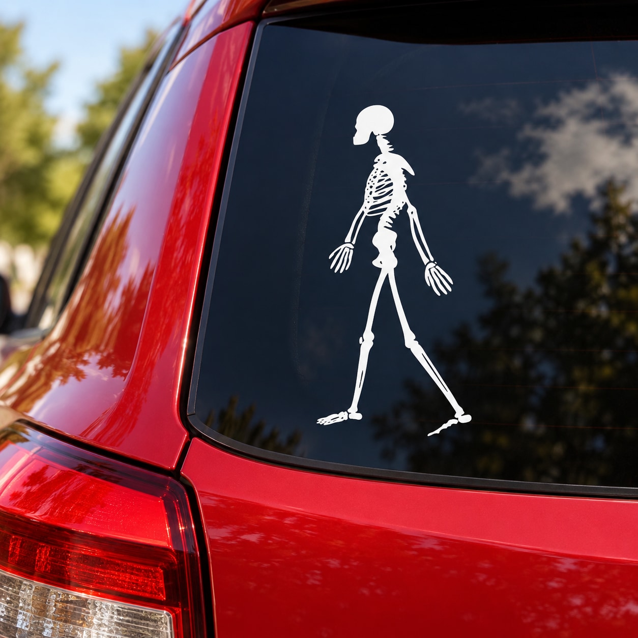 Walking skeleton decal on a car rear window, white
