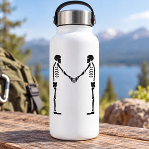 Black skeletons shaking hands graphic decal on a white bottle