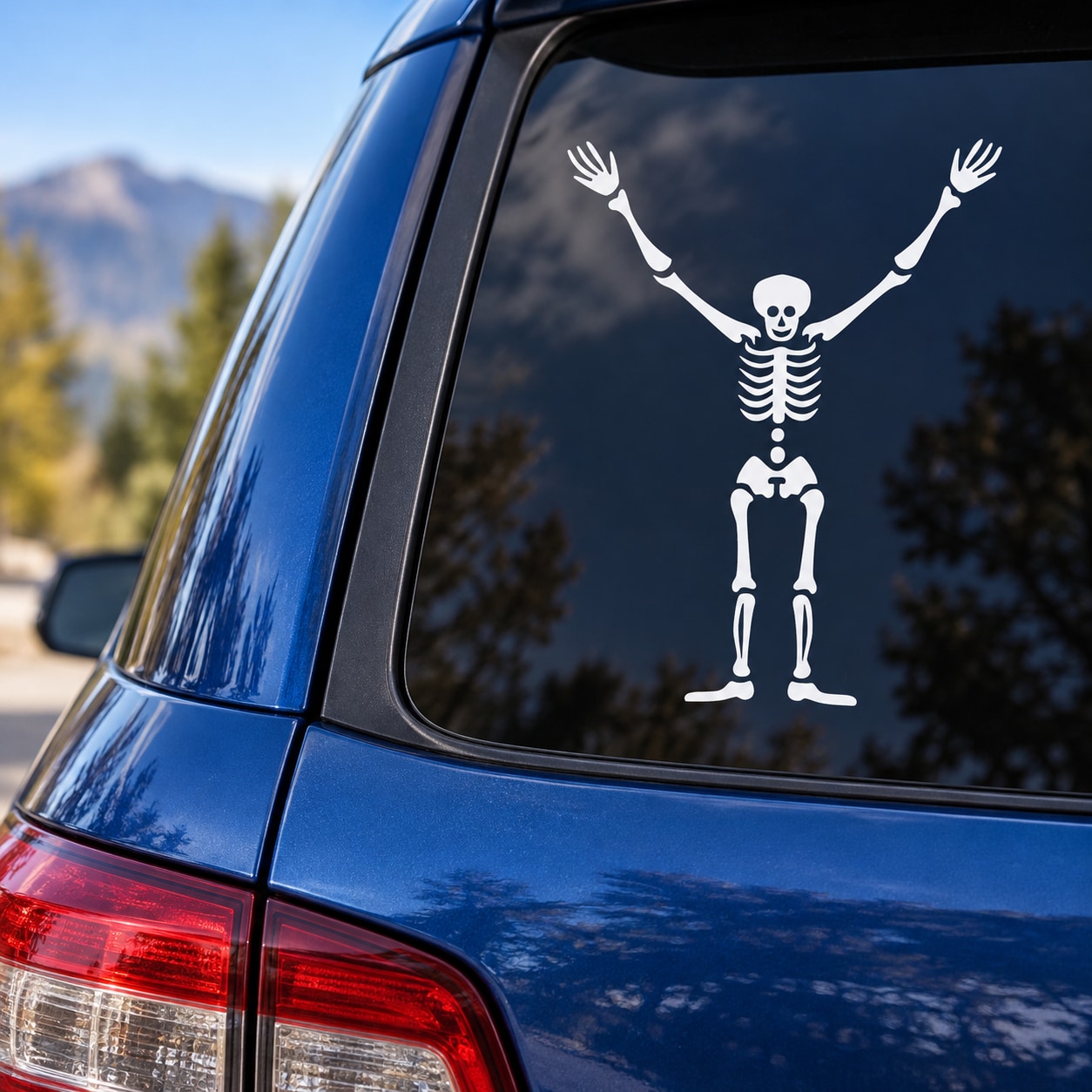 White skeleton hands-up decal on car rear window
