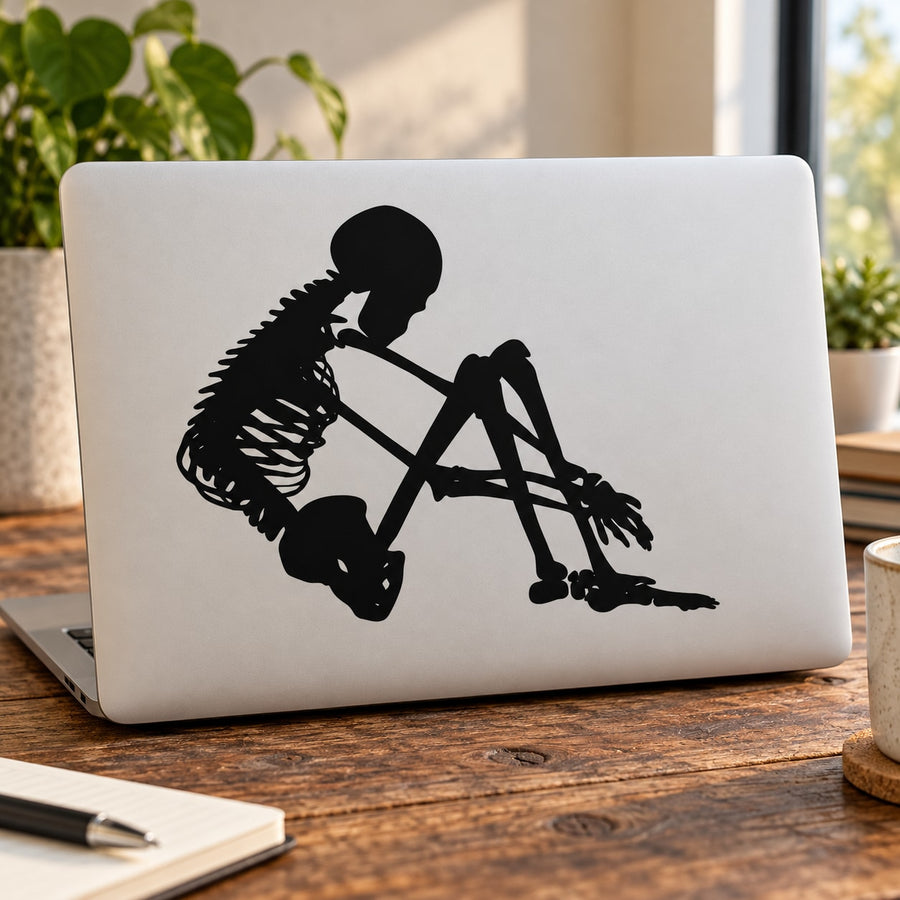 Skeleton holding knees vinyl decal, black silhouette