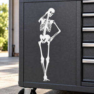 White skeleton decal scratching its head on a dark rectangular panel