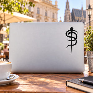 skinny puppy decal with black caduceus-style emblem on a light rectangular backing
