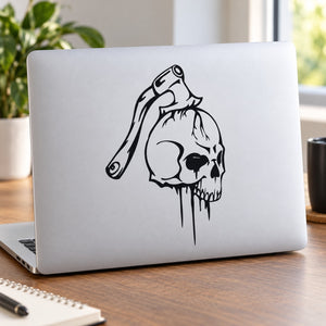 Skull vinyl wall decal with black drip design on a surface
