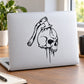 Skull vinyl wall decal with black drip design on a surface