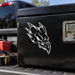 Vinyl skull decal with white flame design on a dark surface