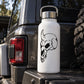 Black vinyl skull decal with bow on white bottle, bold outline graphic