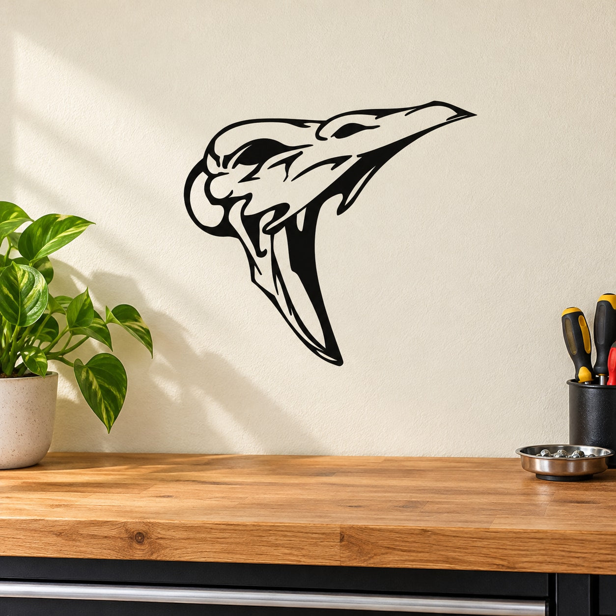 Skull wall vinyl decal with bold black stylized skull and beak-like outline