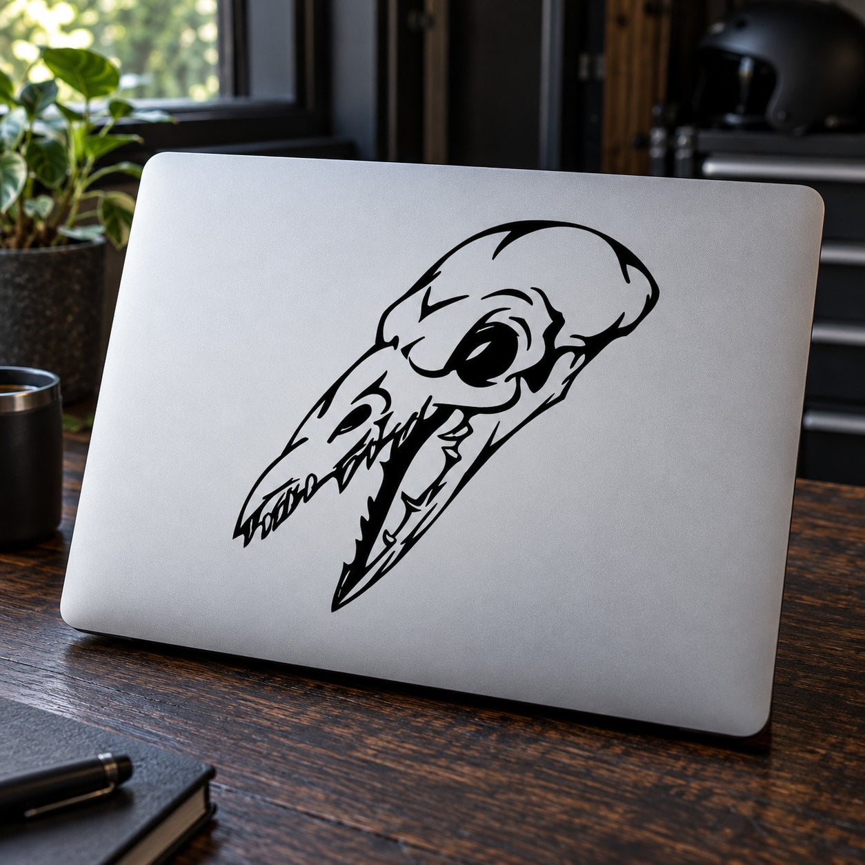Stylized black skull vinyl decal with long beak-like nose