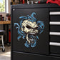 Skull filligree sticker with blue and gold ornate skull graphic on black background