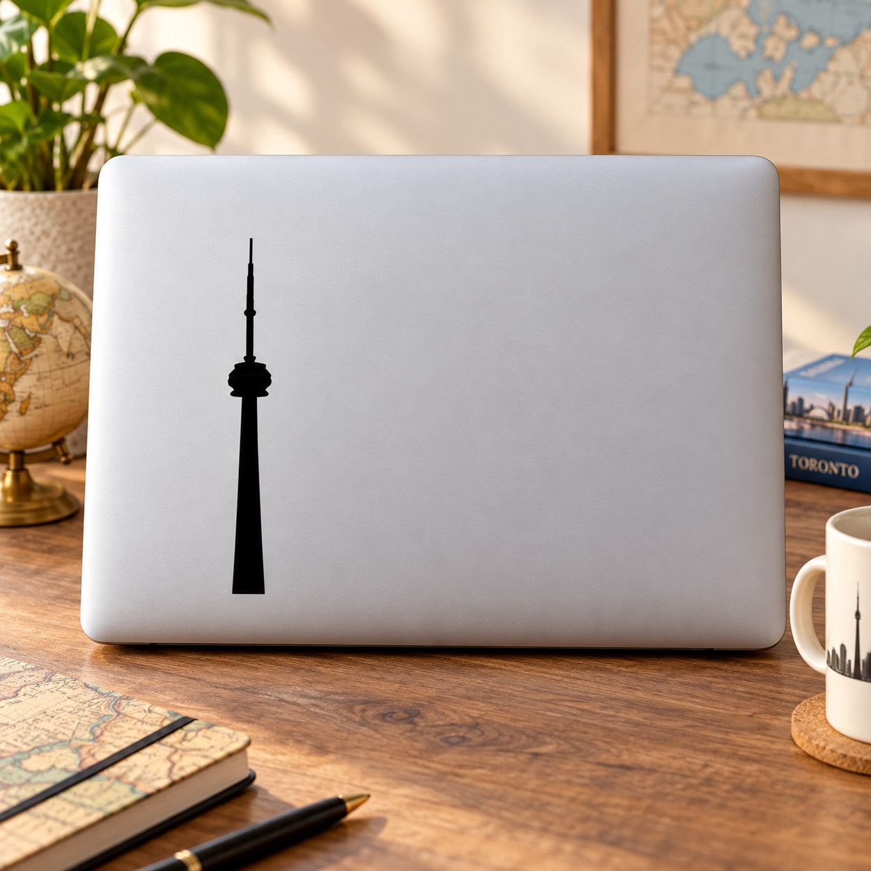 Black CN Tower silhouette decal on white laptop lid
