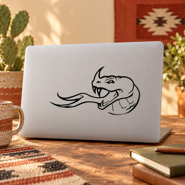 Horned snake head hissing decal in black outline on light laptop lid