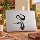 Black snake outline decal sticker on white laptop lid