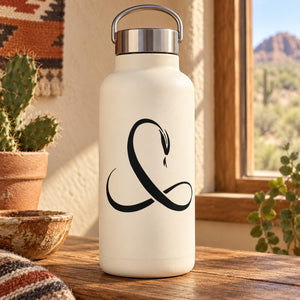 White bottle with black snake decal on the front