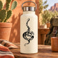 Cream bottle with climbing Indian python snake decal