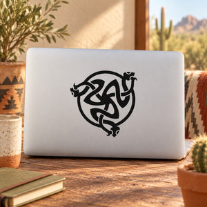 Black interlocking snake decal with ornate knot-style design on light surface
