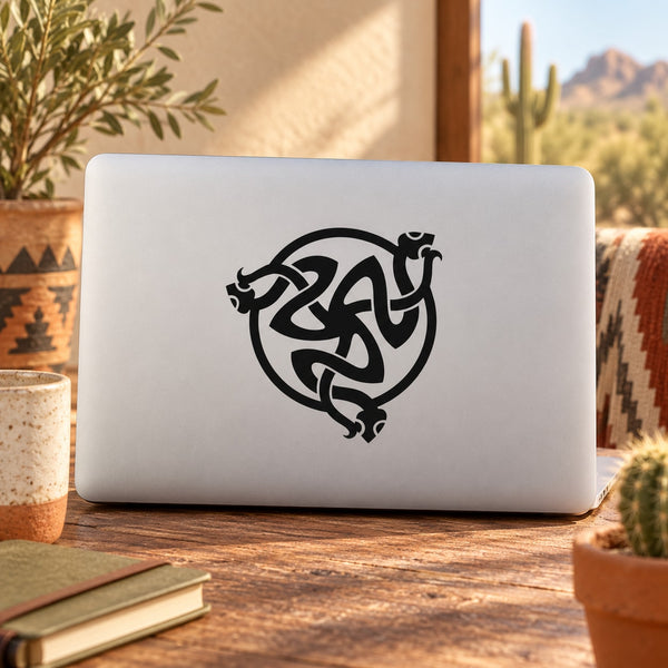 Black interlocking snake decal with ornate knot-style design on light surface