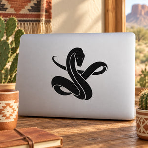 Black snake decal with curled tail on light laptop lid