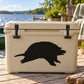 Snapping turtle observing decal on a light-colored cooler lid