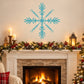 Turquoise snowflake wall decal with layered 3D-style flakes above a fireplace