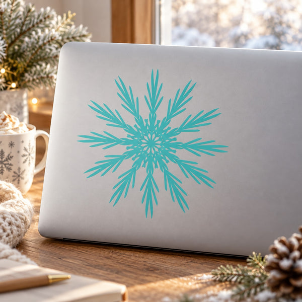Blue snowflake decal on a light gray laptop lid