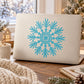 Turquoise snowflake decal on light surface