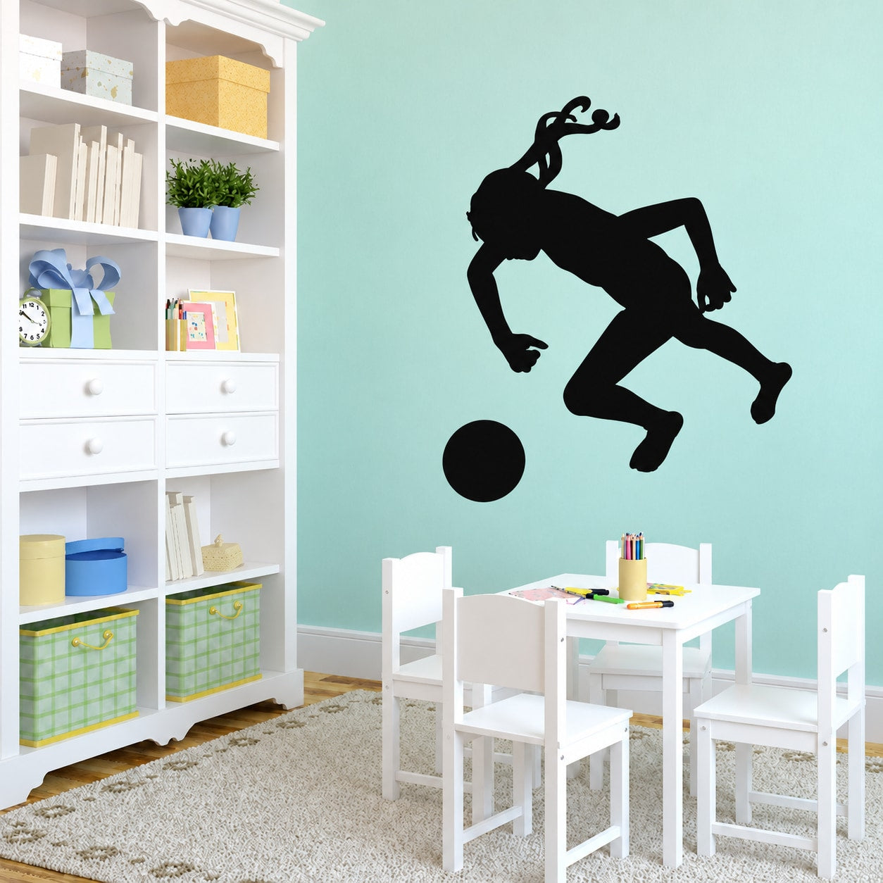 Soccer player wall vinyl decal, black silhouette kicking a ball
