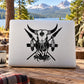 Bull skull graphic decal with crossed spears over campfire, black design on white surface