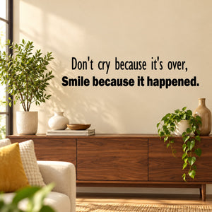 Wall decal with black quote text: "Don't cry because it's over, smile because it happened"